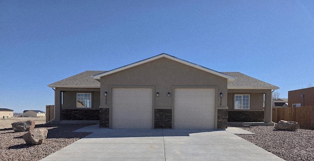 ranch-style house with stucco siding, a shingled roof, concrete driveway, a garage, and stone siding