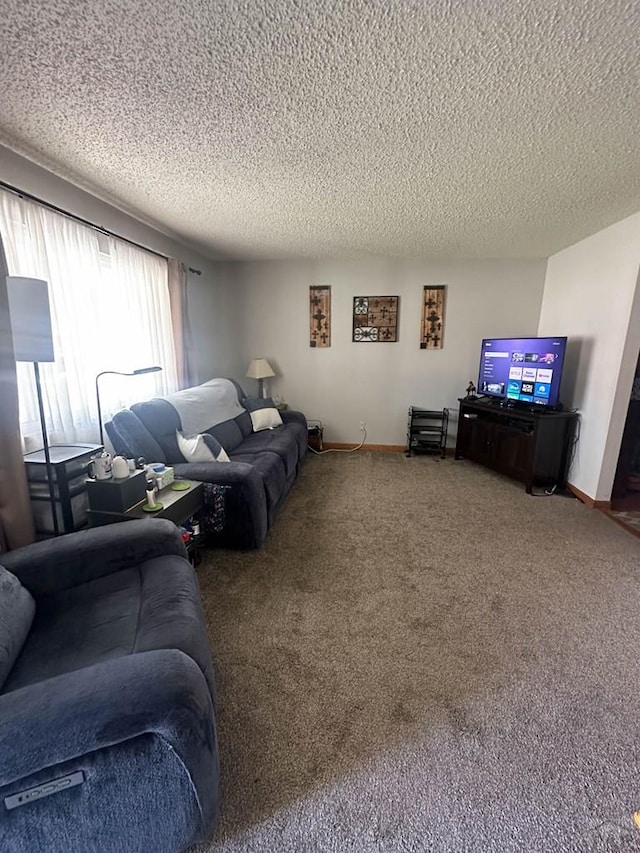 carpeted living area with a textured ceiling and baseboards