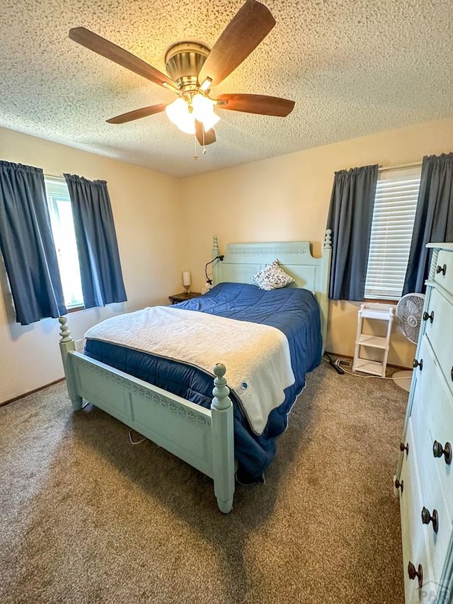 carpeted bedroom featuring a textured ceiling, multiple windows, and ceiling fan