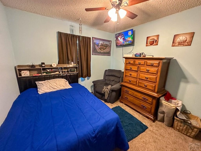 carpeted bedroom featuring a textured ceiling and ceiling fan