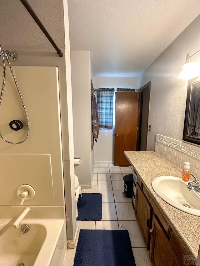 bathroom with a textured ceiling, tile patterned floors, shower / washtub combination, and vanity