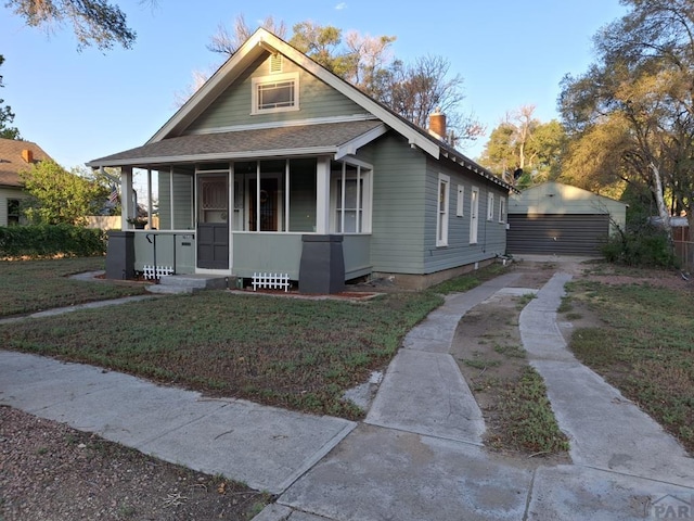 bungalow-style home featuring a front lawn, fence, a porch, and a shingled roof