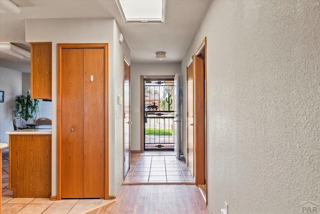137 W Glenrose Dr, Pueblo West, CO 81007 - doorway to outside with light wood-style floors and a textured wall