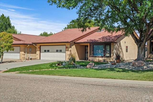 137 W Glenrose Dr, Pueblo West, CO 81007 - mediterranean / spanish house featuring a garage, a tile roof, concrete driveway, and stucco siding