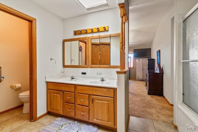 137 W Glenrose Dr, Pueblo West, CO 81007 - full bath with double vanity, a sink, toilet, and tile patterned floors
