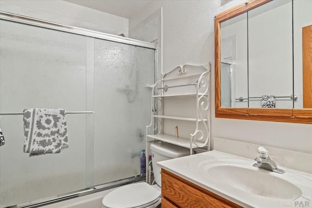 137 W Glenrose Dr, Pueblo West, CO 81007 - bathroom featuring toilet, bath / shower combo with glass door, and vanity