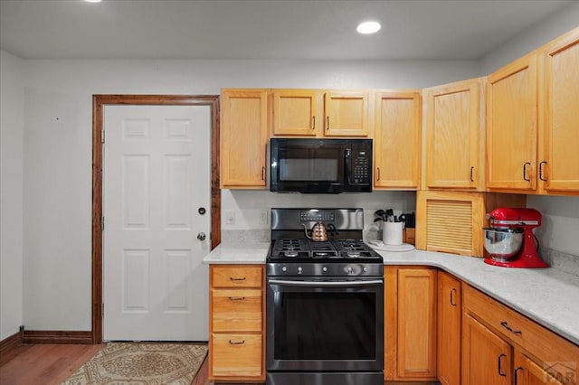 49 N Pkwy, Colorado City, CO 81019 - kitchen with black microwave, gas stove, light countertops, wood finished floors, and recessed lighting
