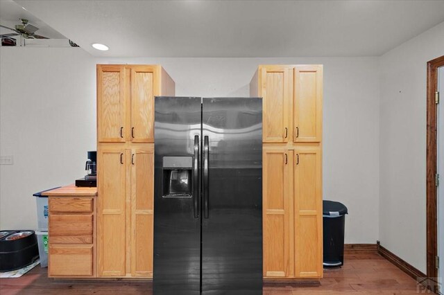 49 N Pkwy, Colorado City, CO 81019 - kitchen featuring stainless steel fridge with ice dispenser, wood finished floors, a ceiling fan, light brown cabinetry, and baseboards