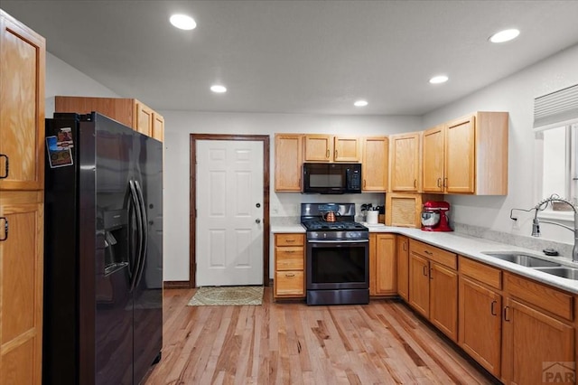 49 N Pkwy, Colorado City, CO 81019 - kitchen featuring black appliances, a sink, light wood-type flooring, light countertops, and recessed lighting