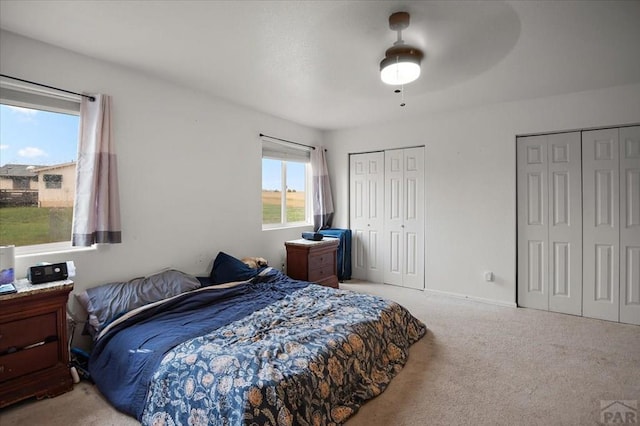 49 N Pkwy, Colorado City, CO 81019 - carpeted bedroom featuring two closets and ceiling fan