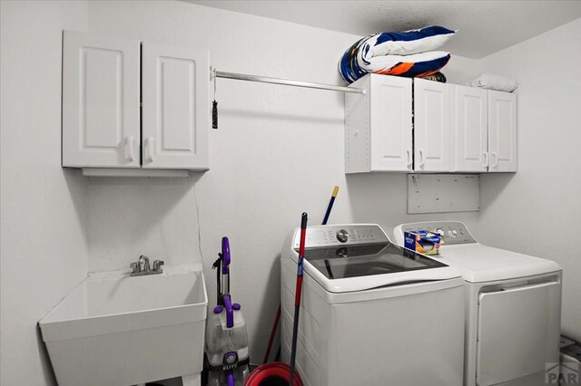 49 N Pkwy, Colorado City, CO 81019 - laundry area featuring separate washer and dryer and cabinet space