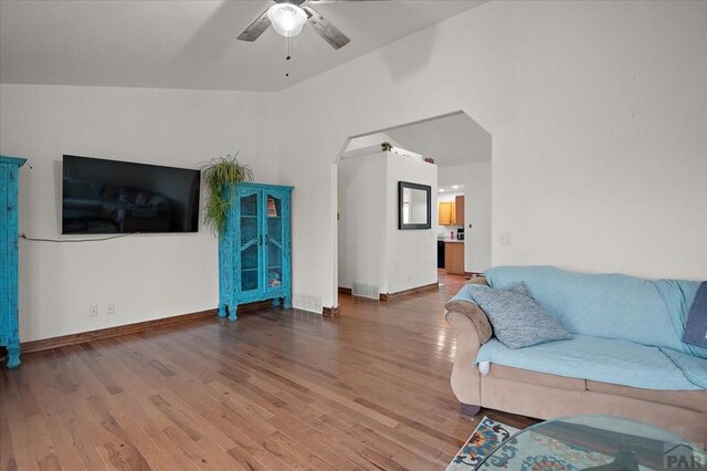 49 N Pkwy, Colorado City, CO 81019 - living area with a ceiling fan, wood finished floors, arched walkways, and baseboards