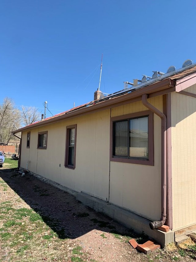 view of property exterior with a chimney