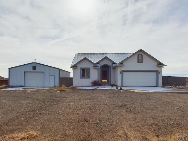 ranch-style house featuring a garage and stucco siding