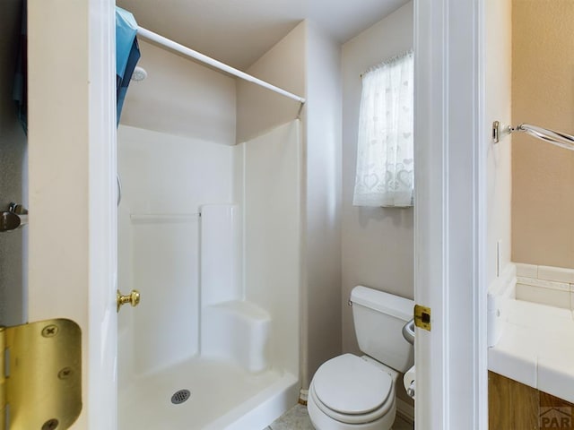 full bath featuring toilet and a shower stall