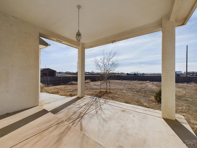 view of patio featuring fence