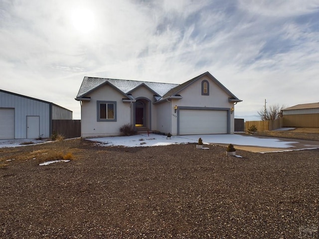 single story home with driveway, a garage, and stucco siding