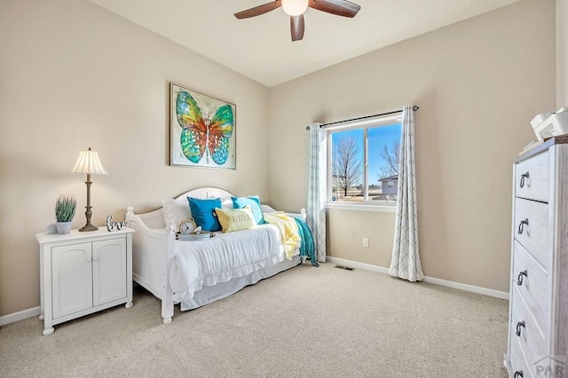 bedroom featuring baseboards, light carpet, visible vents, and a ceiling fan