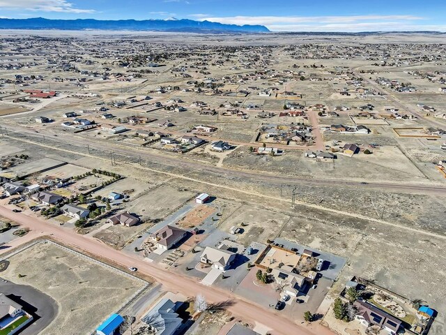 aerial view featuring a mountain view and a desert view