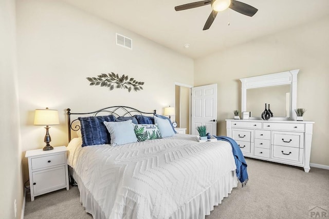 bedroom featuring light carpet, visible vents, baseboards, and ceiling fan