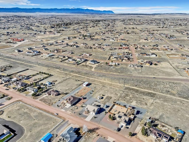 drone / aerial view with a desert view and a mountain view