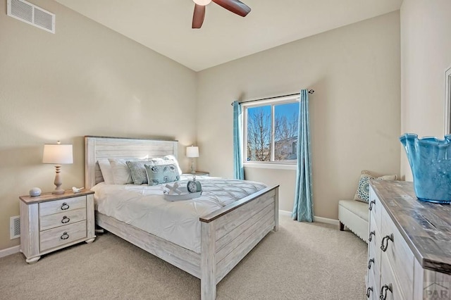 bedroom featuring ceiling fan, light colored carpet, visible vents, and baseboards