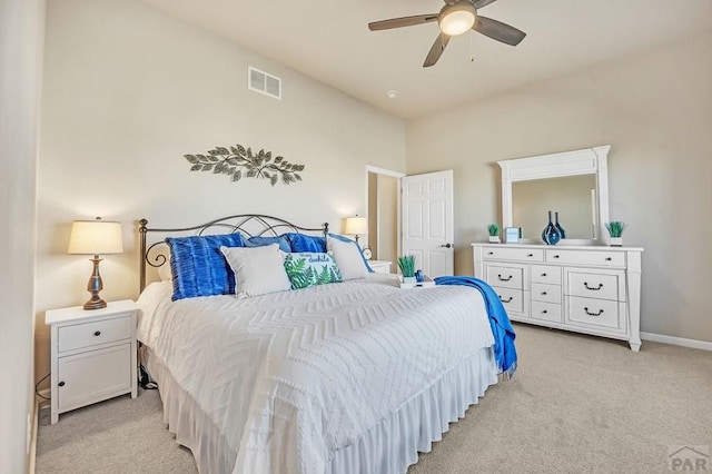 bedroom featuring ceiling fan, baseboards, visible vents, and light carpet