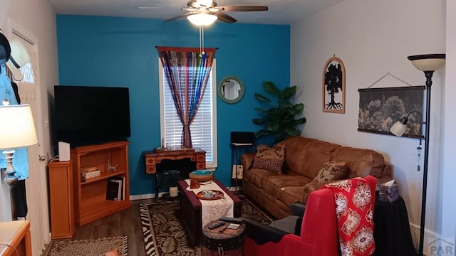 living area with plenty of natural light, wood finished floors, and a ceiling fan