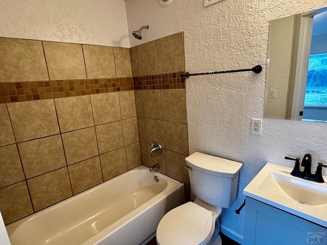 full bath featuring shower / bath combination, a textured wall, vanity, and toilet