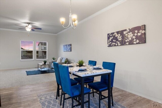 dining area featuring ornamental molding, wood finished floors, and baseboards