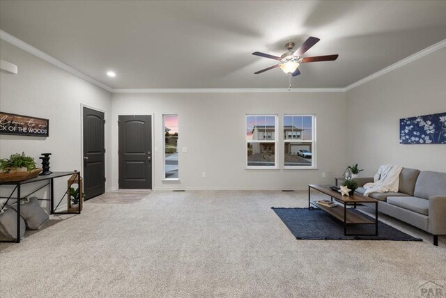 living area featuring ornamental molding, light colored carpet, ceiling fan, and baseboards