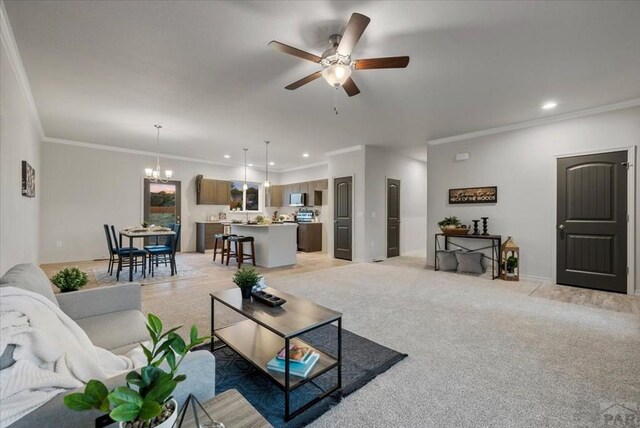 living room with recessed lighting, light colored carpet, crown molding, and ceiling fan with notable chandelier