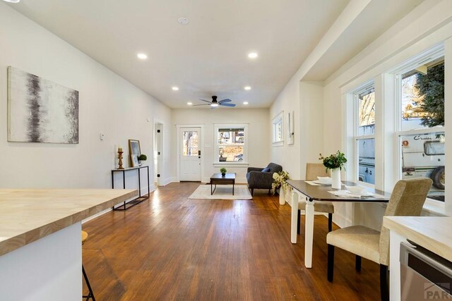 dining area featuring recessed lighting, dark wood-type flooring, a ceiling fan, beverage cooler, and baseboards