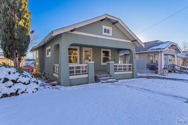 view of front of house featuring covered porch and stucco siding