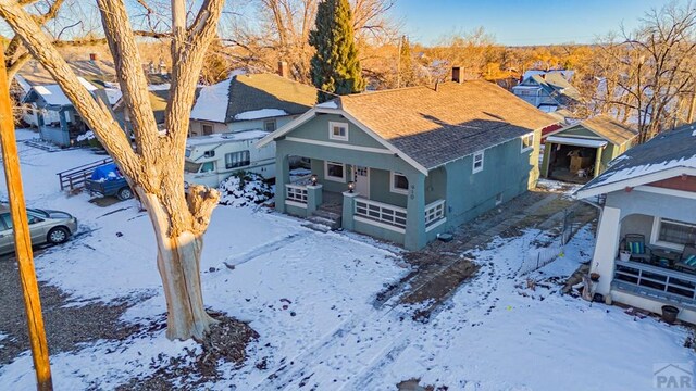 snowy aerial view with a residential view