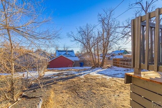 yard layered in snow with fence