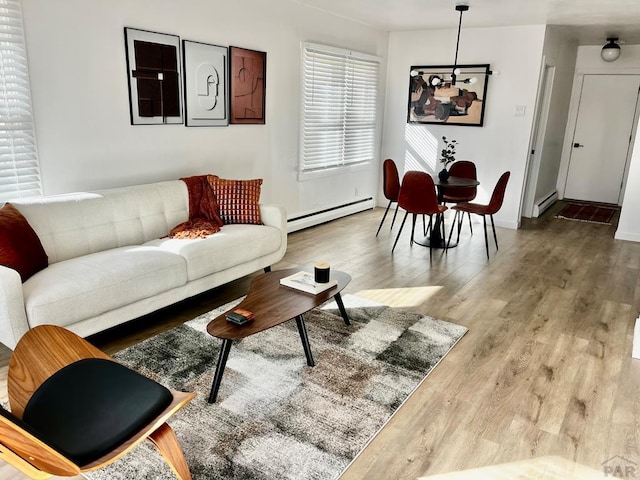 living area with a baseboard radiator and wood finished floors