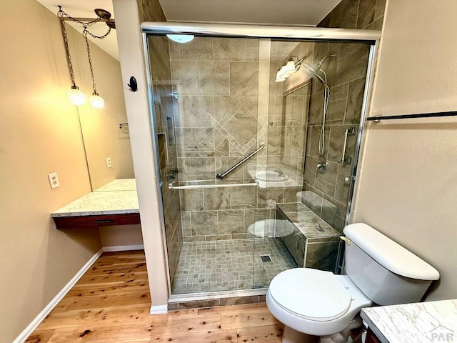 2302 Cartier Dr Unit A, Pueblo, CO 81005 - bathroom featuring vanity, wood finished floors, and a stall shower