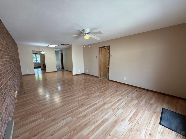2302 Cartier Dr Unit A, Pueblo, CO 81005 - unfurnished room with a ceiling fan, light wood-type flooring, and brick wall