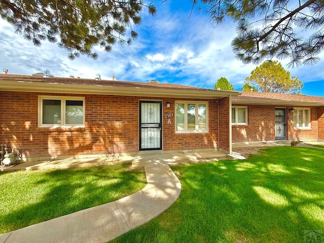 2302 Cartier Dr Unit A, Pueblo, CO 81005 - ranch-style home with a front lawn and brick siding