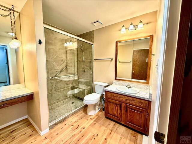 2302 Cartier Dr Unit A, Pueblo, CO 81005 - bathroom with hardwood / wood-style floors, a shower stall, and vanity