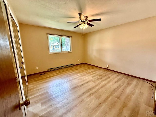 2302 Cartier Dr Unit A, Pueblo, CO 81005 - unfurnished room with baseboard heating, a ceiling fan, and wood finished floors