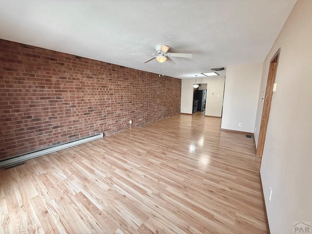 2302 Cartier Dr Unit A, Pueblo, CO 81005 - unfurnished room with brick wall, a ceiling fan, and light wood-type flooring