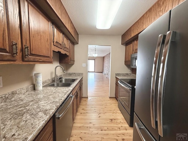 2302 Cartier Dr Unit A, Pueblo, CO 81005 - kitchen featuring appliances with stainless steel finishes, light wood-type flooring, and light countertops