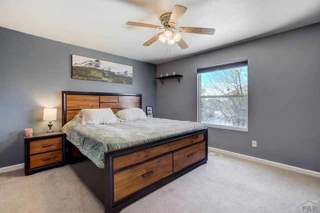 bedroom featuring baseboards, ceiling fan, and light carpet