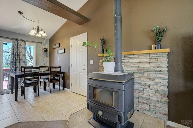 details featuring an inviting chandelier, baseboards, and a wood stove