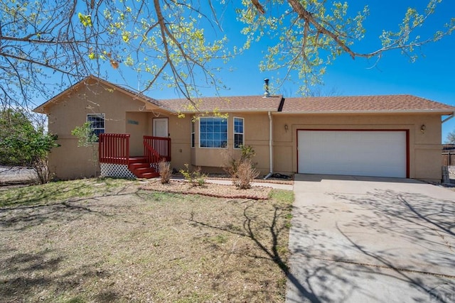 single story home featuring a garage, stucco siding, and driveway