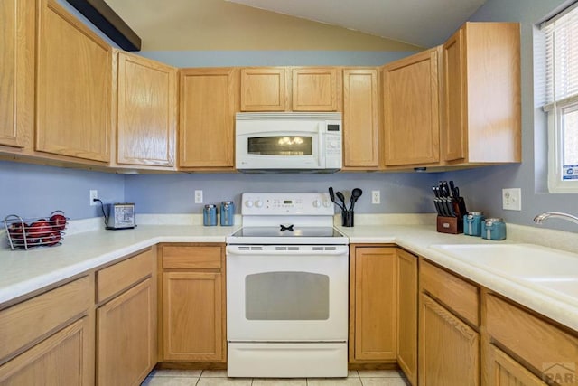 kitchen with light countertops, light tile patterned floors, lofted ceiling, and white appliances