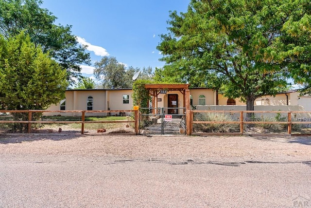 view of front of house featuring a fenced front yard and a gate