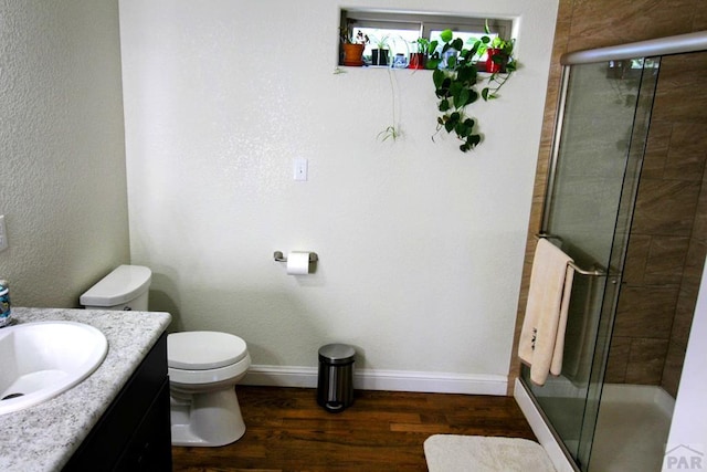 1470 Villa Spanada, Pueblo, CO 81006 - bathroom featuring vanity, wood finished floors, and a stall shower